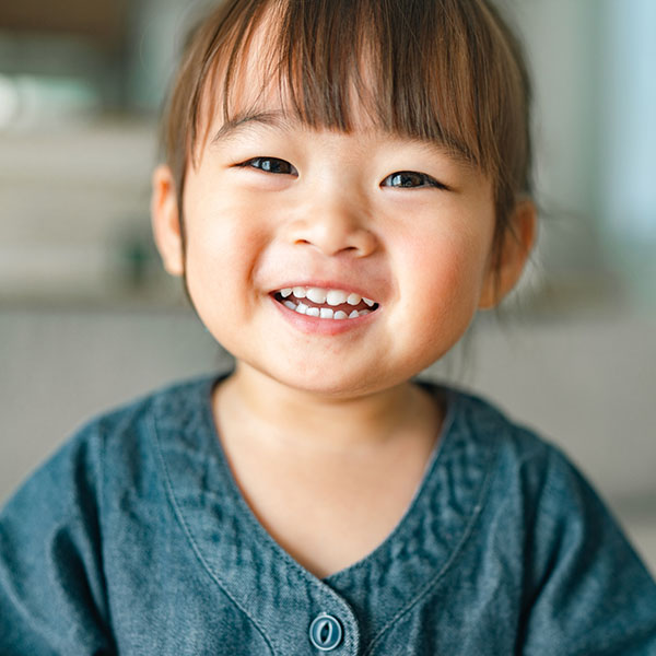 Portrait of small girl in living room at home