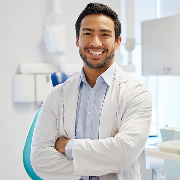 young dentist working in his consulting room